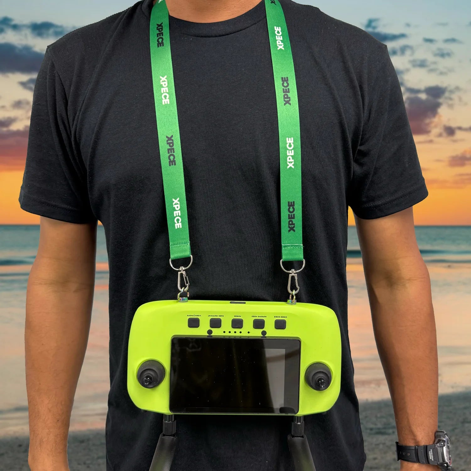 Person wearing XPECE lanyard neck strap holding XPECE remote controller (lifestyle photo)