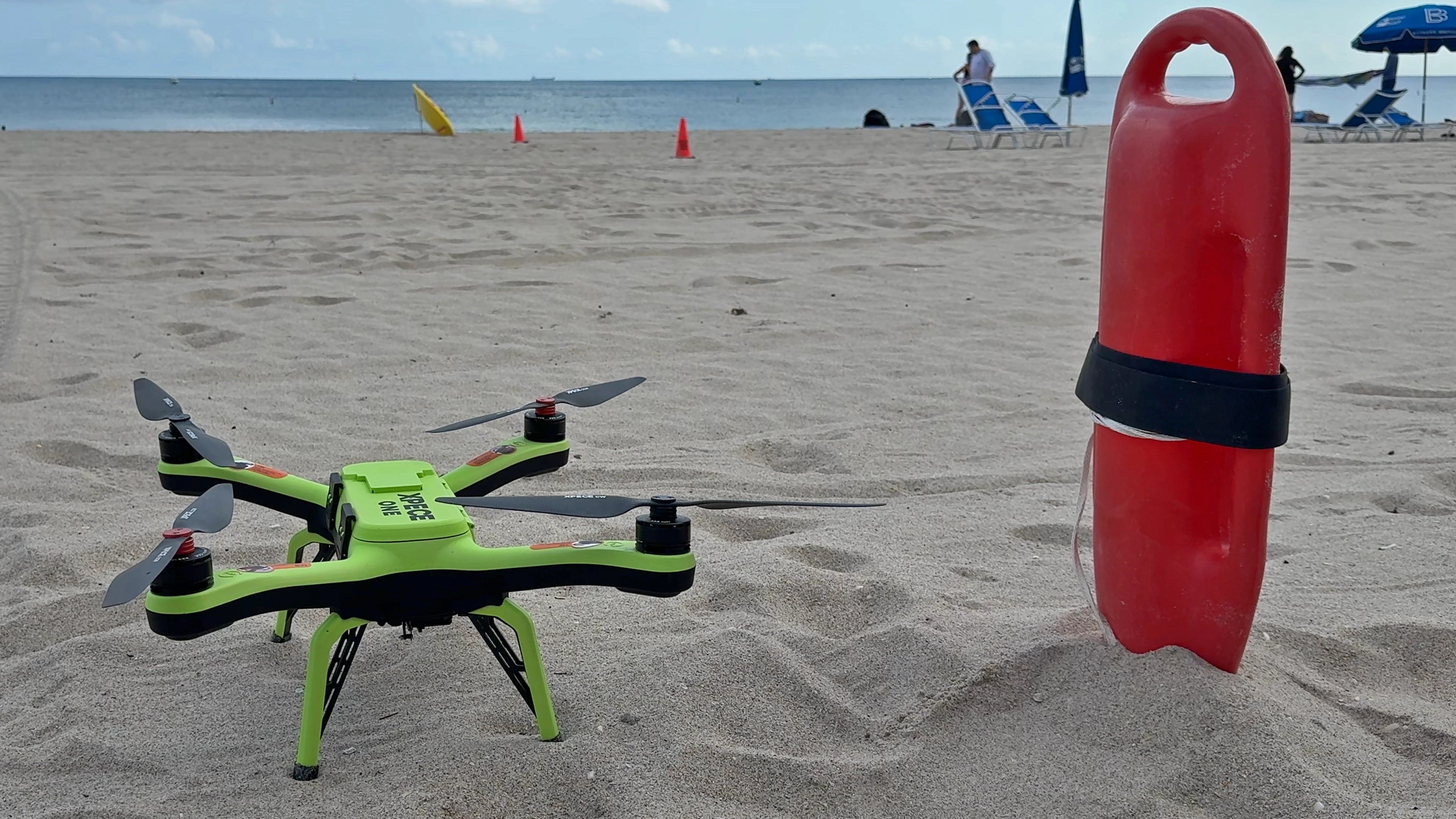 Xpece Rescue Drone on a sandy beach next to a rescue buoy