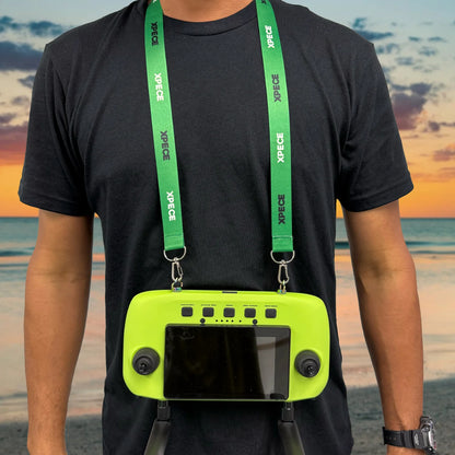 Person wearing XPECE lanyard neck strap holding XPECE remote controller (lifestyle photo)